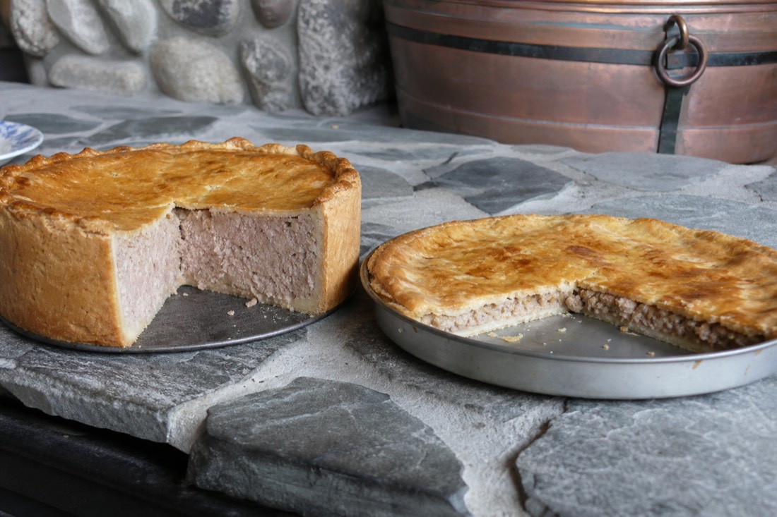 Deep-dish Tourtiere du Lac-Saint-Jean cut open beside a shallow spiced pork tourtiere