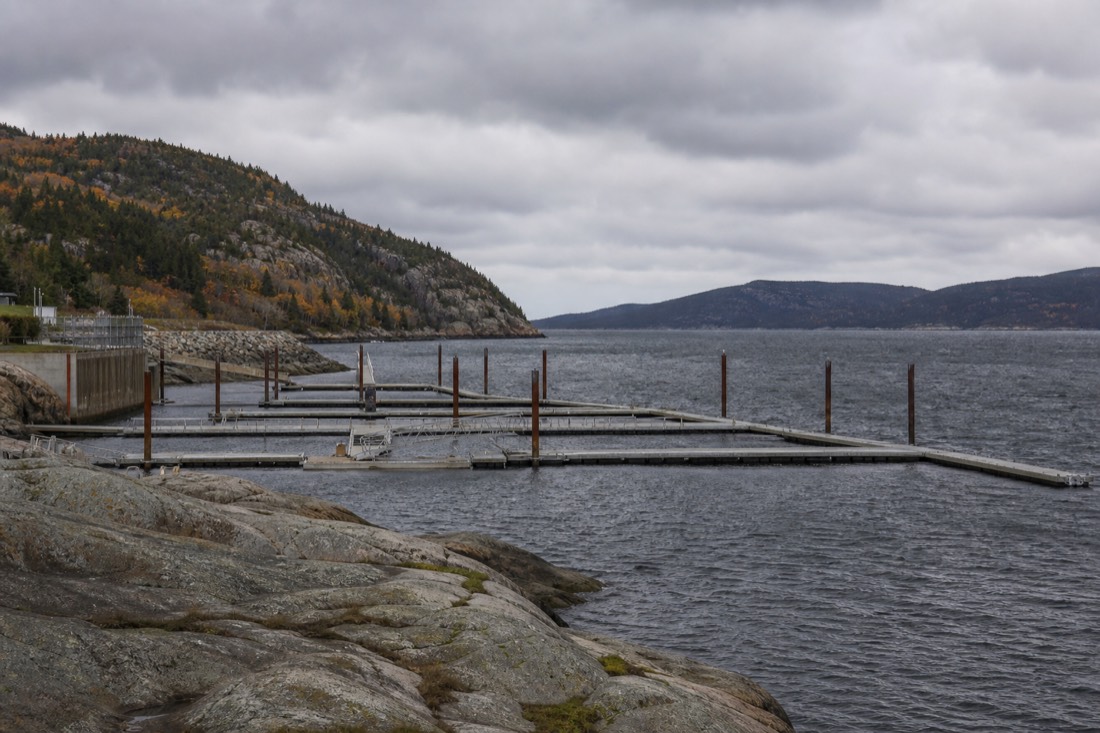 Grey November day on the St. Lawrence shore with empty whale watching docks at Tadoussac