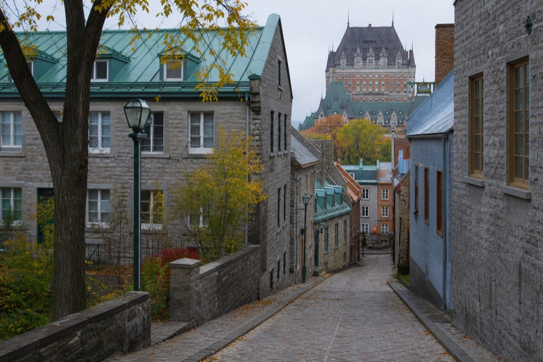Quiet cobbled street in Old Quebec on a crisp October morning with autumn leaves and few tourists