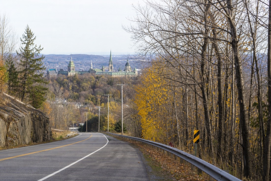 Road heading north from Quebec City toward Wendake through suburban woodland