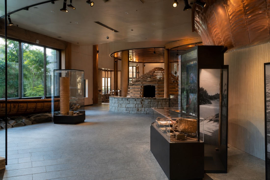 Interior gallery of the Huron-Wendat Museum in Wendake with display cases and interpretive panels