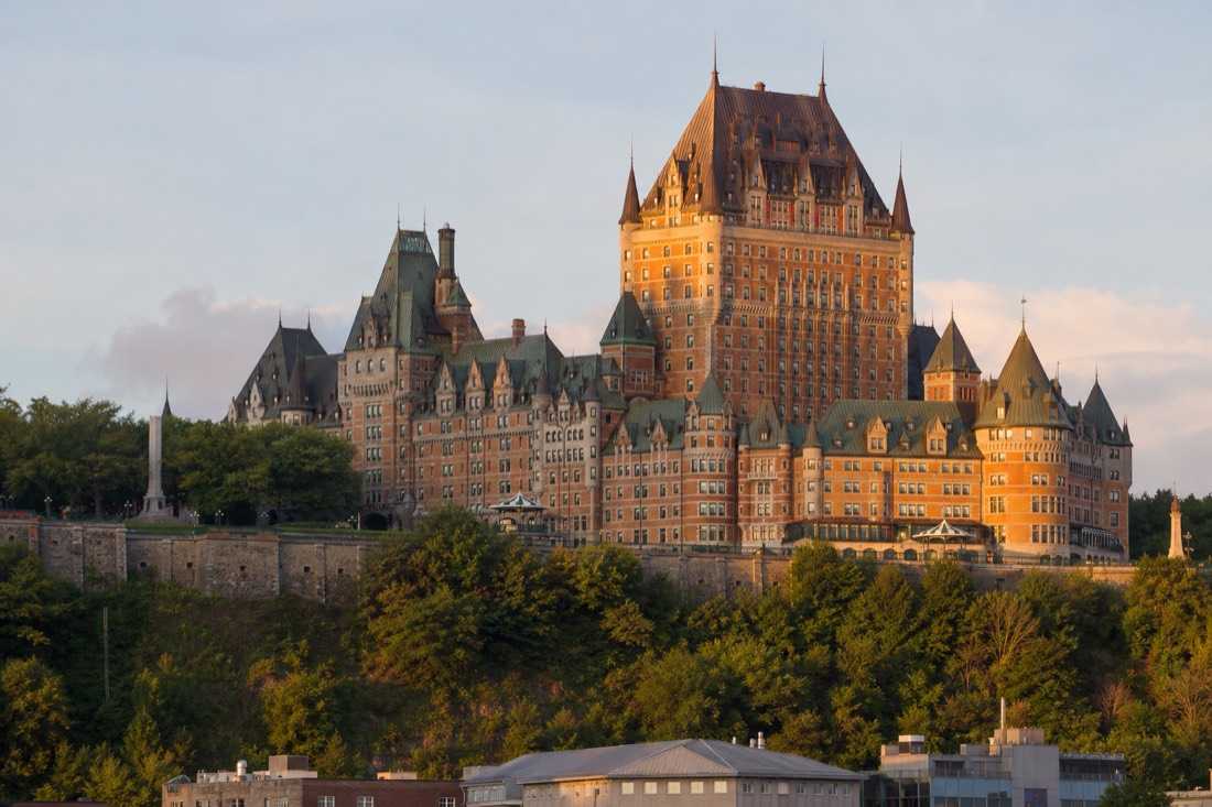 Golden evening light on the copper roofs of the Château Frontenac above the cliff in Quebec City