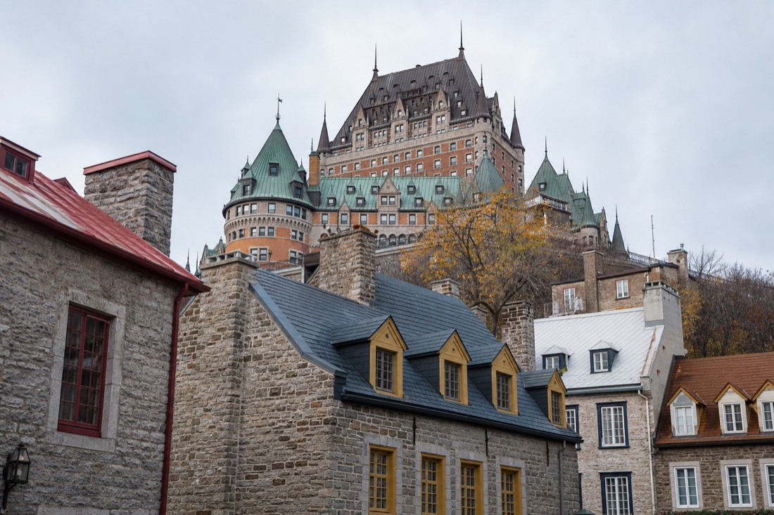The Château Frontenac towers seen rising above the rooftops of the Petit Champlain district in Lower Town