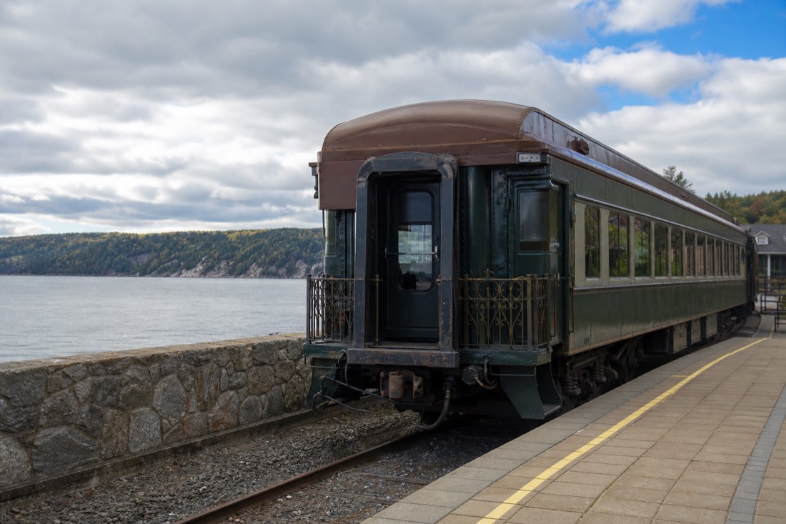 Train de Charlevoix carriage waiting at the Chute-Montmorency station beside the St. Lawrence