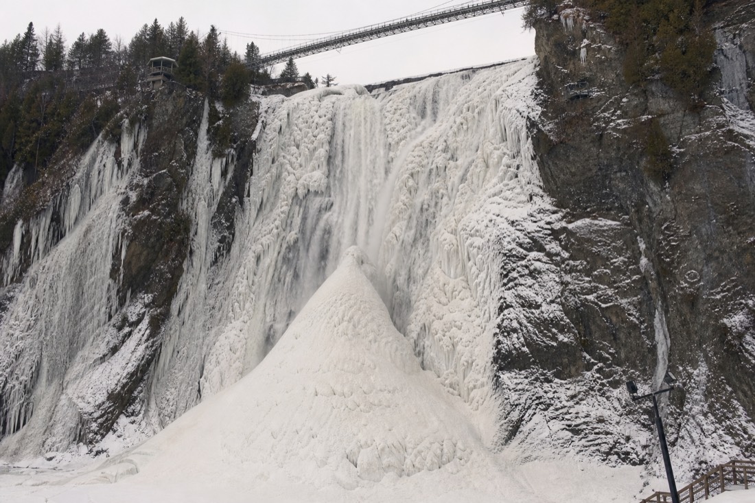 Frozen Montmorency Falls in winter with the ice cone forming at its base