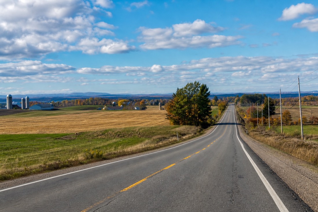 Highway 20 heading east toward Quebec City with open farmland on both sides