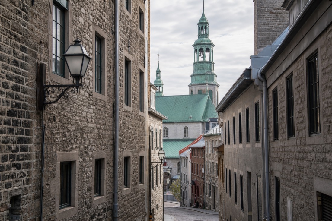 Narrow Old Quebec street between Place d'Armes and the Notre-Dame basilica on a walking tour route