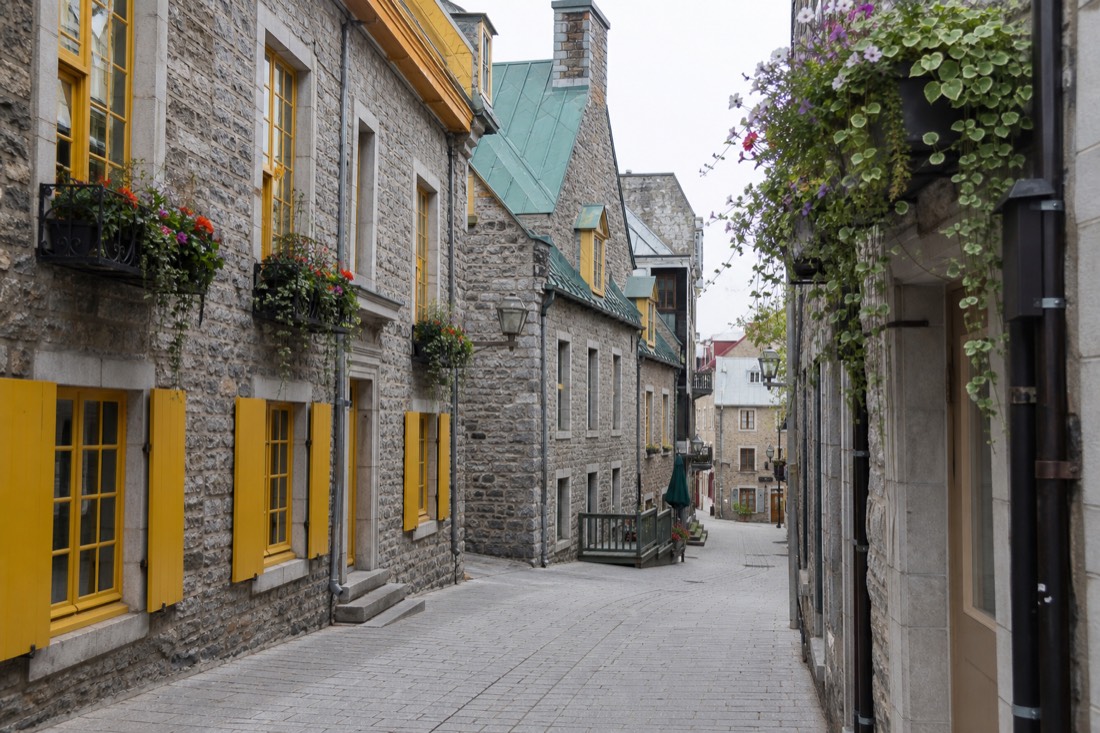 Quartier Petit-Champlain pedestrian street in Lower Town Quebec City with stone houses and flower boxes