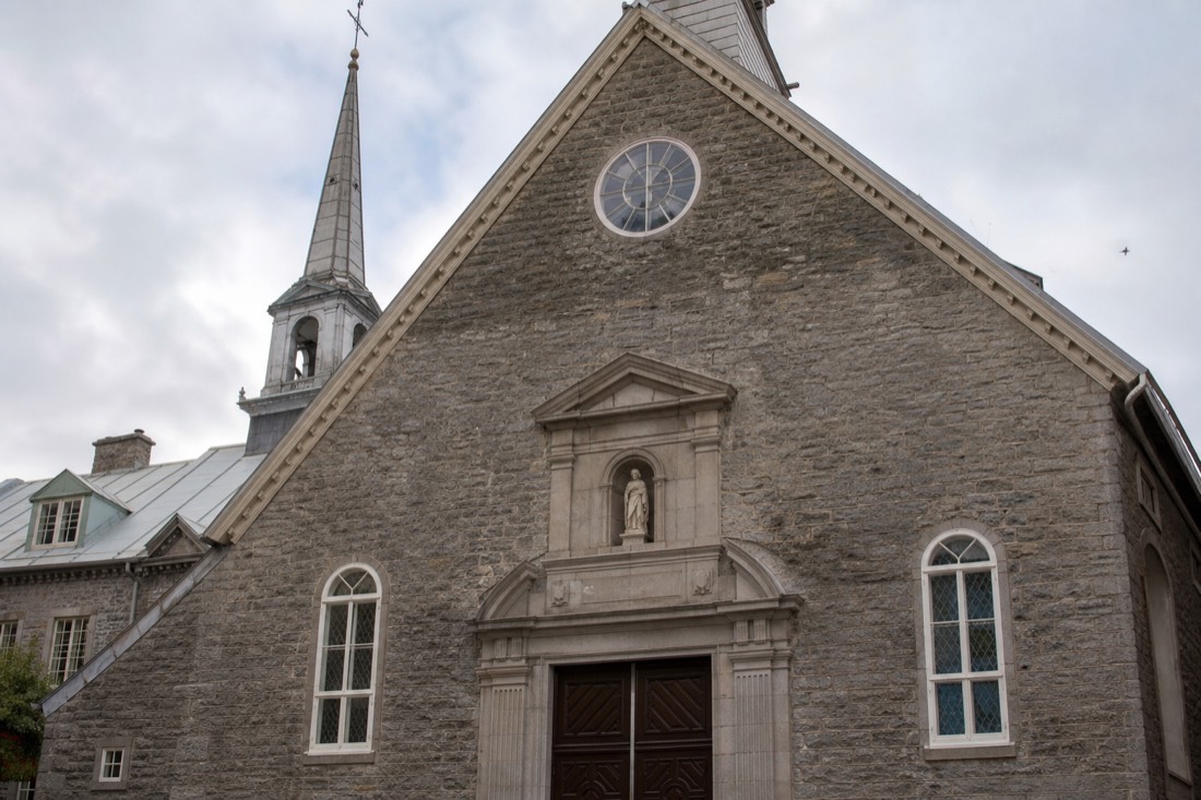 Stone facade of Notre-Dame-des-Victoires church on Place Royale in Old Quebec City