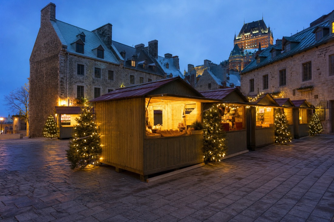 Lit wooden kiosks at the Quebec City German Christmas Market on an evening in December in Old Quebec