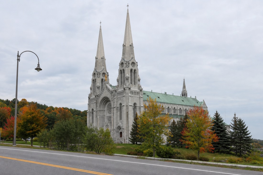 Exterior of the Basilica of Sainte-Anne-de-Beaupre with its twin spires seen from the road east of Quebec City