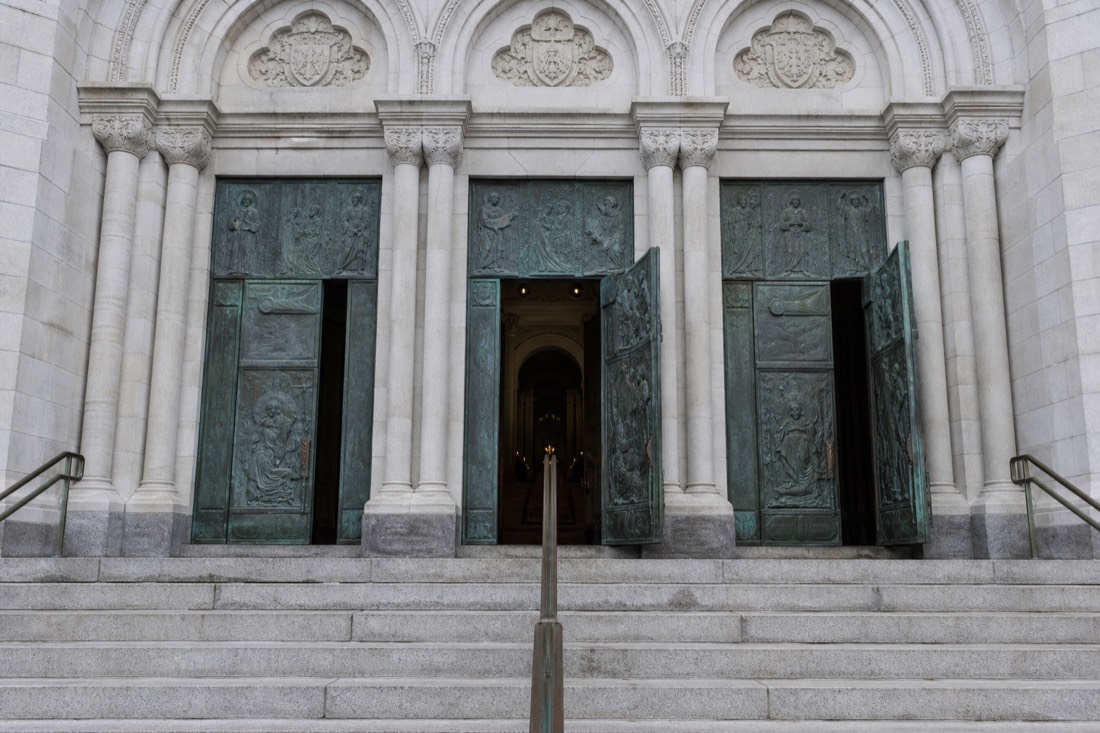 Visitors entering the free-admission Sainte-Anne-de-Beaupre basilica through the main doors