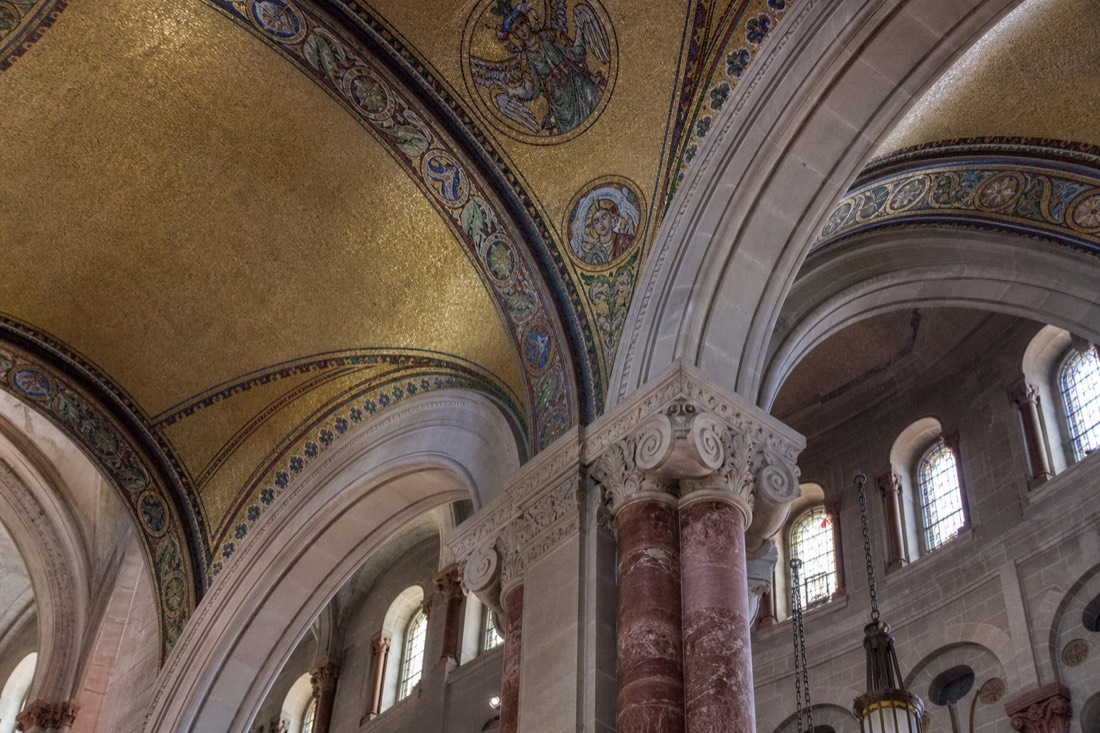 Secular visitors photographing the mosaic ceiling and columns inside the Sainte-Anne-de-Beaupre basilica